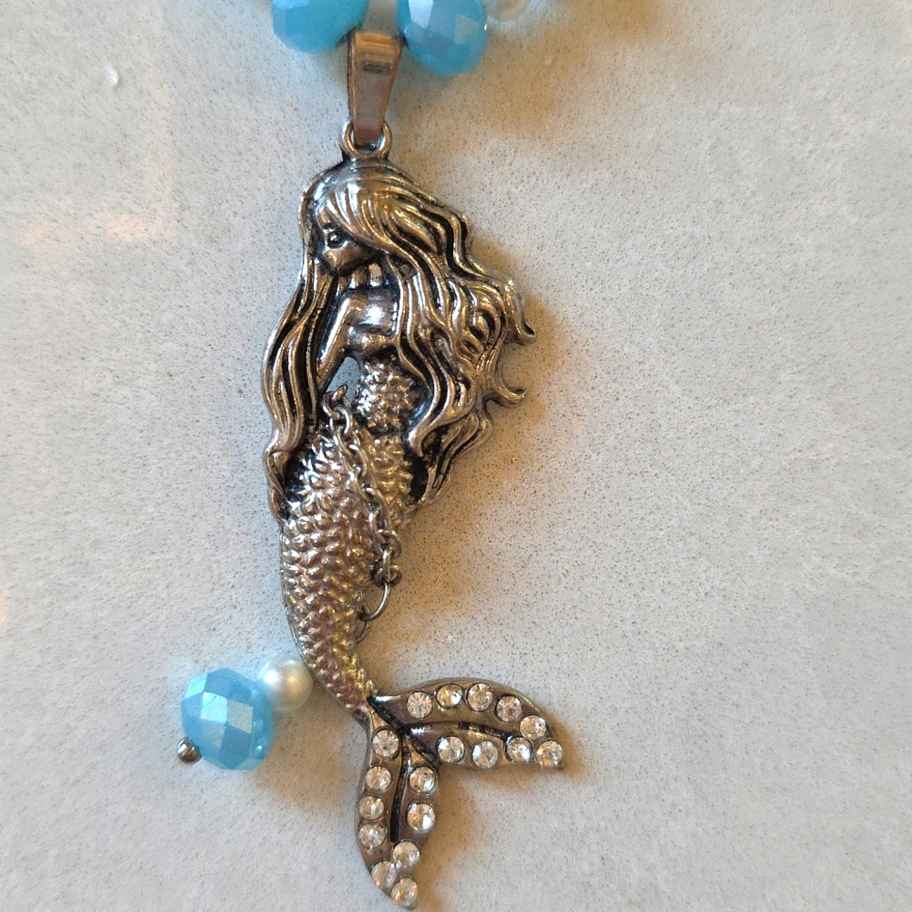 Metal mermaid set with necklace, wine bottle stopper and cheese marker.